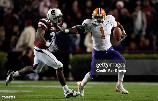 Darian Stewart of the South Carolina Gamecocks is stiff armed by James Davis of the Clemson Tigers during the first half at Williams-Brice Stadium on...