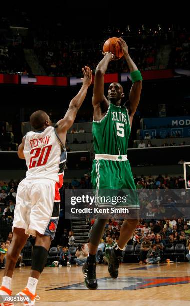 Kevin Garnett of the Boston Celtics takes a jump shot over Rayond Felton of the Charlotte Bobcats during the game at the Charlotte Bobcats Arena...