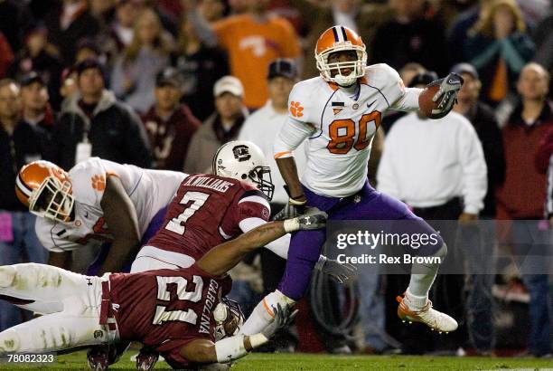 Emanuel Cook and teammate Addison Williams of the South Carolina Gamecocks work to bring down Aaron Kelly of the Clemson Tigers during the second...