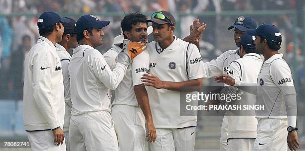 India cricket captain Anil Kumble and other cricketers congratulate Sourav Ganguly for the wicket of Pakistan's Mohammad Sami during the fourth day...
