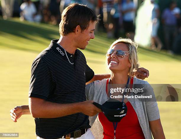 Aaron Baddeley of Australia is congratulated by his wife Richelle after winning the MasterCard Masters at Huntingdale Golf Course on November 25,...