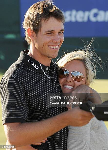 Aaron Baddeley of Australia hugs his wife Richelle after winning the Australian Masters golf tournament after beating Daniel Chopra of Sweden on the...