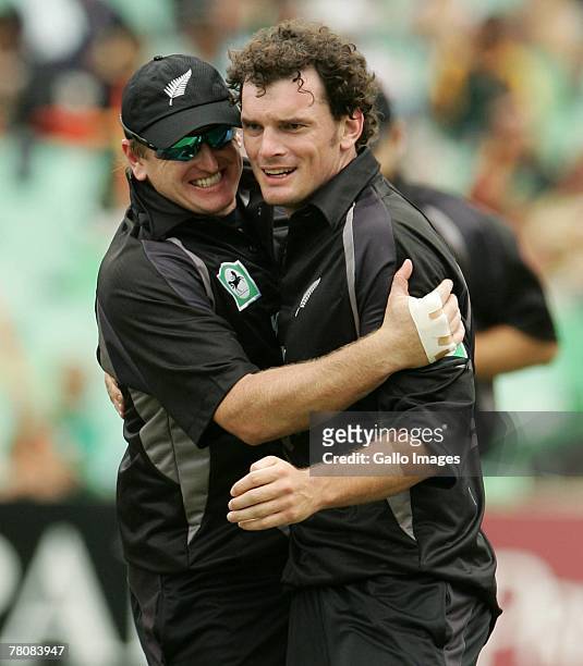 Scott Styris and Kyle Mills of New Zealand celebrate the wicket of Jacques Kallis of south Africa leaves the field out for 40 runs during the first...