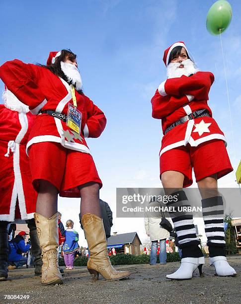 Two women, dressed as Santa Claus, wear high heeled boots, 25 November 2007 during the Santa Claus championships Brandenburg-Berlin in Potsdam,...