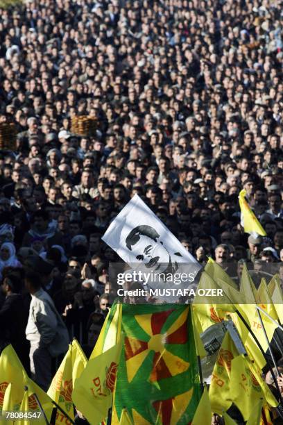 Kurds wave their party flags and a picture of Kurdish rebel leader Abdullah Ocalan during a Democratic Society Party's meeting "Enough's enough", in...