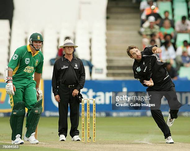 Daniel Vettori of New Zealand in action while Graeme Smith of South Africa looks on during the first ODI match between South Africa and New Zealand...