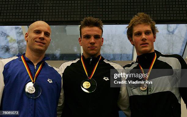 Jan Wolfgarten of SV Wuerzburg , Paul Biedermann of SV Halle and Christian Kubusch of SC Magdeburg pose for a photo during the medal ceremony of the...