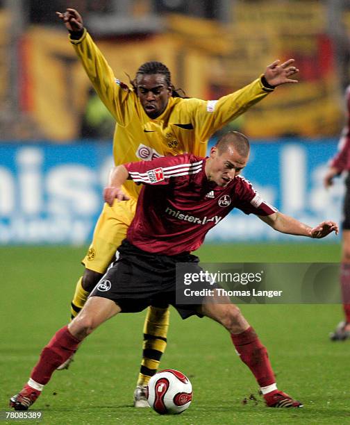 Peer Kluge of Nuremberg and Tinga of Dortmund in action during the Bundesliga match between 1. FC Nuremberg and Borussia Dortmund at the...