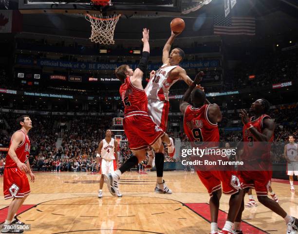 Jamario Moon of the Toronto Raptors goes up for a dunk against Andres Nocioni of the Chicago Bulls on November 25, 2007 at the Air Canada Centre in...