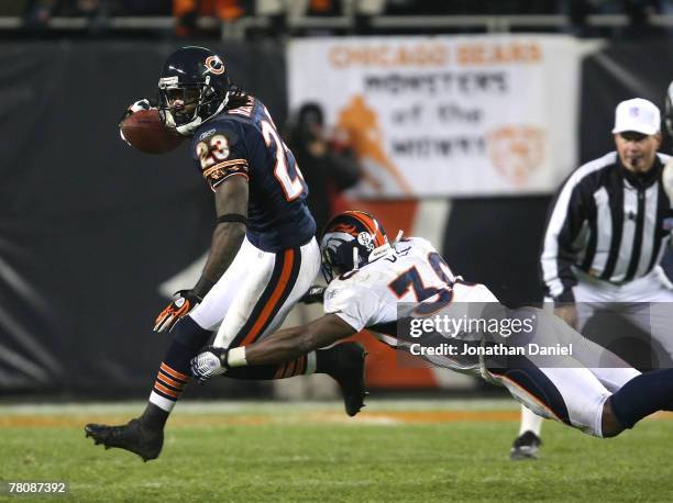 Devin Hester of the Chicago Bears breaks away from Mike Bell of the Denver Broncos on November 25, 2007 at Soldier Field in Chicago, Illinois.