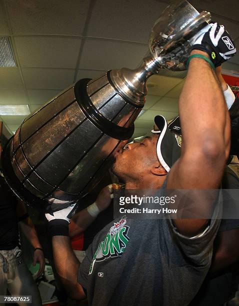 Most Valuable Player James Johnson of the Saskatchewan Rough Riders kisses the trophy after a victory over the Winnipeg Blue Bombers during the 95th...