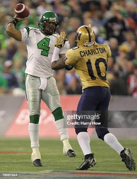 Kerry Joseph of the Saskatchewan Rough Riders scrambles as he passes over Ike Charlton of the Winnipeg Blue Bombers during the third quarter of the...