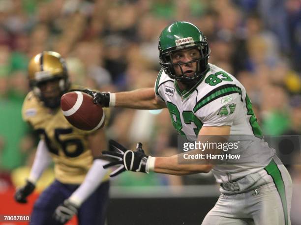 Andy Fantuz of the Saskatchewan Rough Riders races to the end zone to score a touchdown in front of Kliff Kingsbury of the Winnipeg Blue Bombers...