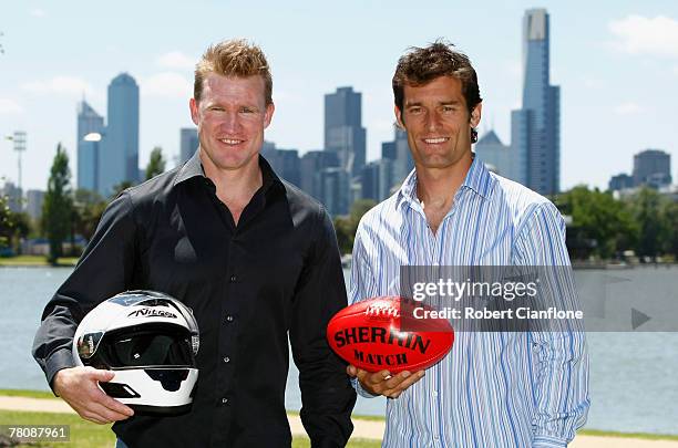 Former AFL footballer Nathan Buckley and Mark Webber of Australia and the Red Bull Formula One Team pose for the media after a press conference to...