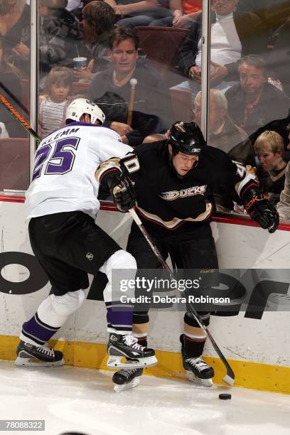 Corey Perry of the Anaheim Ducks is checked into the boards by Jon Klemm of the Los Angeles Kings at the Honda Center November 25, 2007 in Anaheim,...