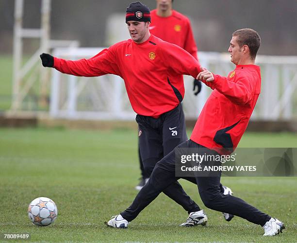 Manchester United footballers John O'Shea and Nemanja Vidic take part in a team training session at the Carrington training ground, in Manchester, in...