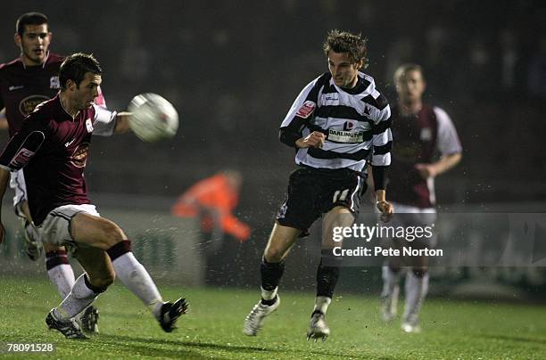 Rob Purdie of Darlington plays the ball past Joe Burnell of Northampton Town during the F.A.Cup Sponsored by E.ON First Round Replay Match between...