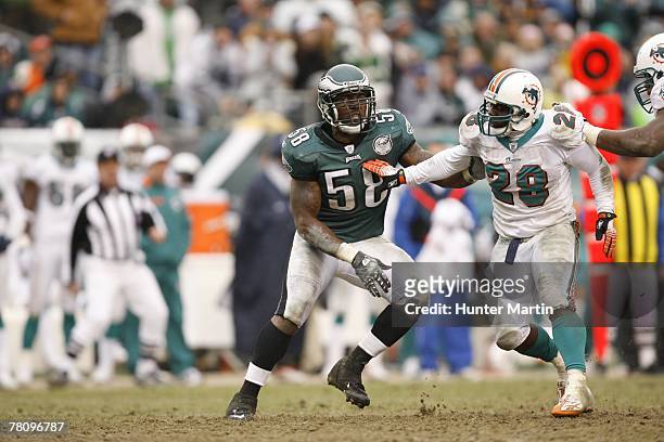Defensive end Trent Cole of the Philadelphia Eagles tries to get around running back Jesse Chatman of the Miami Dolphins during a game on November...