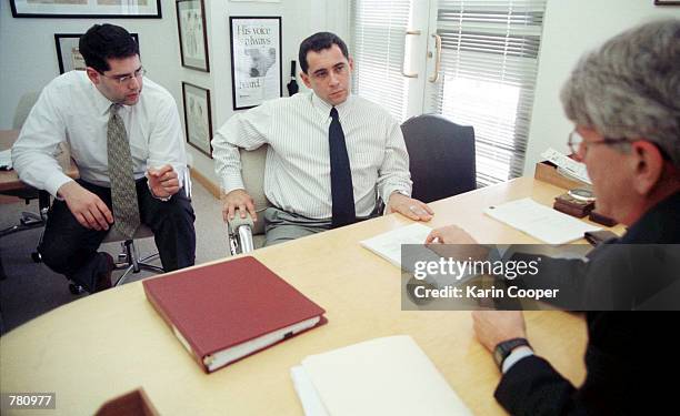 Juan Miguel Gonzalez, center, speaks with attorney Gregory Craig, right, and spanish speaking attorney Oliver Garcia, left, in Craig's office April...