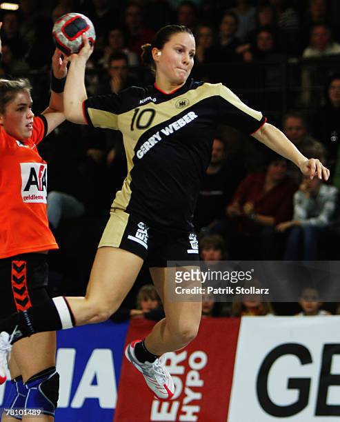 Anna Loerper of Germany throws the ball during the handball match between Germany and the Netherlands on November 26, 2007 in Lubbecke, Germany.