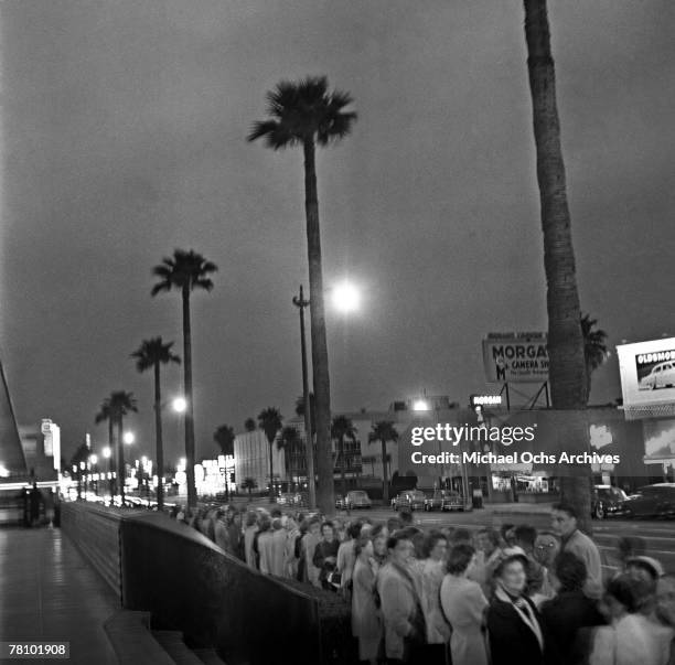 Crowds wait outside a movie premiere on Hollywood Boulevard at night on June 7 1951 in Los Angeles California.