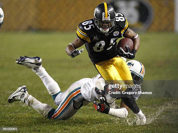 Nate Washington of the Pittsburgh Steelers tries to escape the tackle of Jason Allen of the Miami Dolphins at Heinz Field November 26, 2007 in...