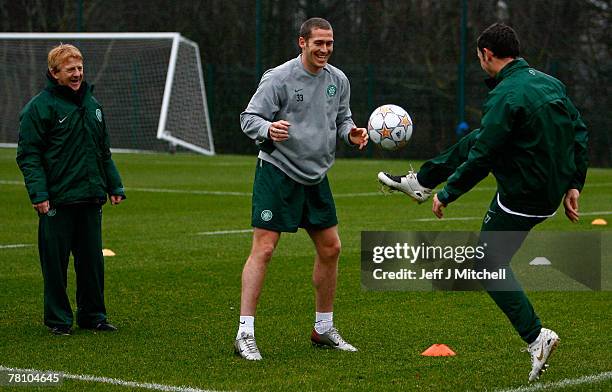 Chris Killen and Scott McDonald of Celtic are watched by Gordon Strachan during a training session ahead of their Champions league match against...