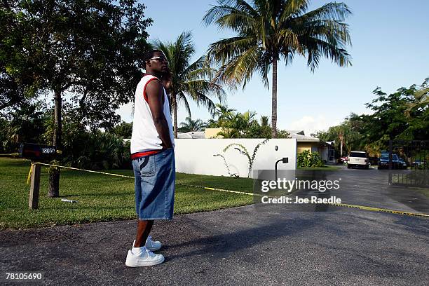 Person who said he was a family friend stands in front of the home where an intruder shot and killed Washington Redskins football player Sean Taylor...