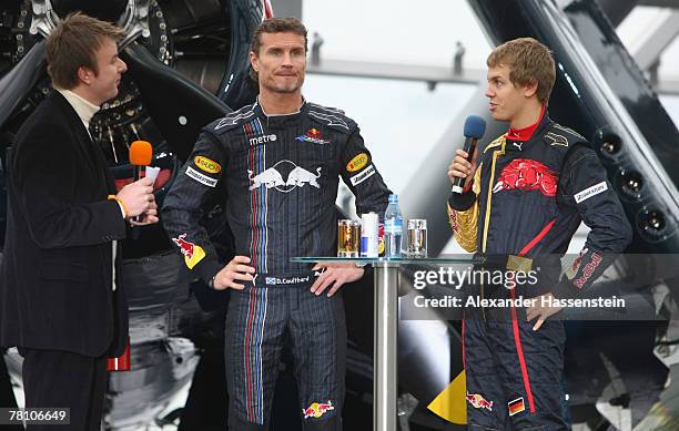 David Coulthard of the Red Bull Formula One Team and Sebastian Vettel of the Torro Rosso Team are interviewed on the stage during the Puma Red Bull...