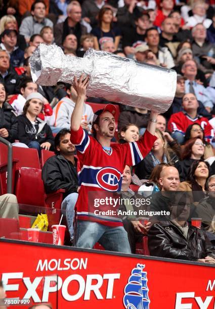 Montreal Canadiens fan holds up a home-made Stanley Cup at a game against the Ottawa Senators at the Bell Centre on November 19, 2007 in Montreal,...