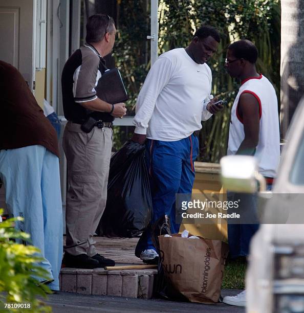 Pedro Taylor the father of Washington Redskins football player Sean Taylor carries material from the home that his son was killed in a day earlier...