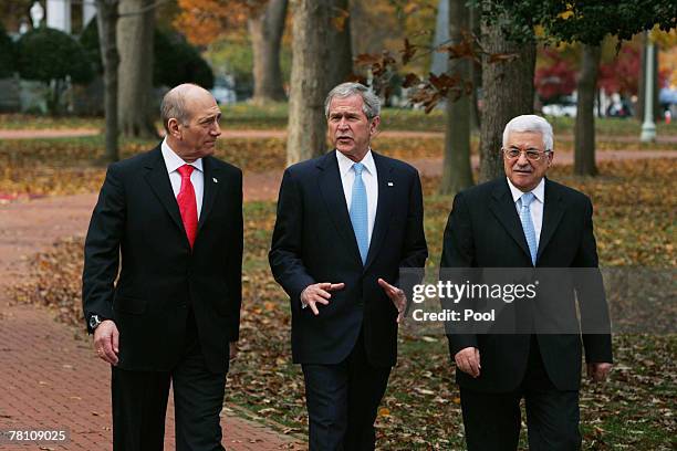 President George W. Bush walks with Israeli Prime Minister Ehud Olmert and Palestinian Authority President Mahmoud Abbas to the joint statement...