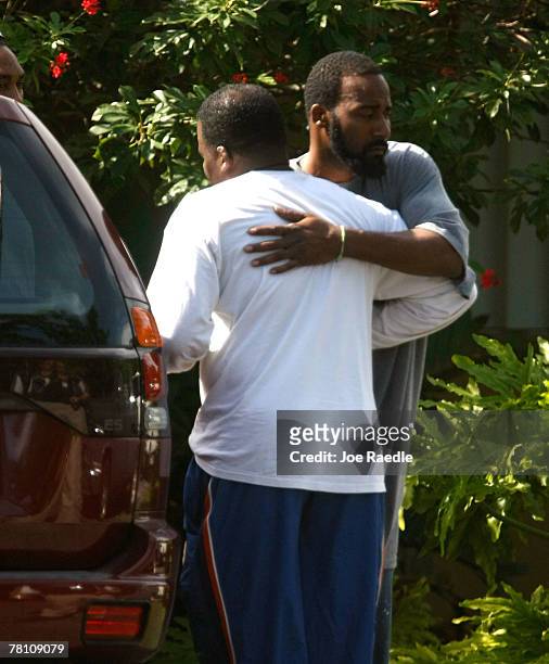 Man hugs Pedro Taylor the father of Washington Redskins football player Sean Taylor as he visits the home that his son was killed in a day earlier...