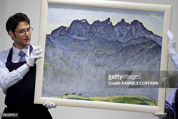 Sotheby's employees display Ferdinand Hodler's oil painting "Les Dents du Midi" during an auction on Swiss arts, 27 November 2007 in Zurich. The...