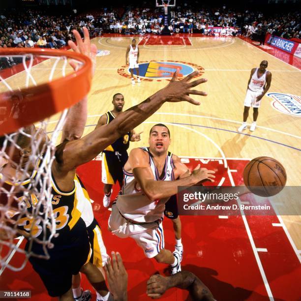 Brian Williams of the Los Angeles Clippers shoots against Dale Davis of the Indiana Pacers on January 3, 1996 at the Los Angeles Sports Arena in Los...