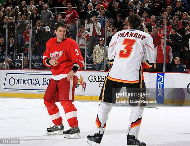 Andreas Lilja of the Detroit Red Wings and Dion Phaneuf # of the Calgary Flames square off during an NHL game on November 27, 2007 at Joe Louis Arena...