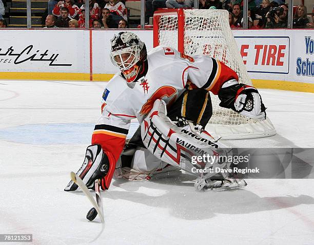 Miikka Kiprusoff of the Calgary Flames stops a shot wide during the NHL game against the Detroit Red Wings on November 27, 2007 at Joe Louis Arena in...