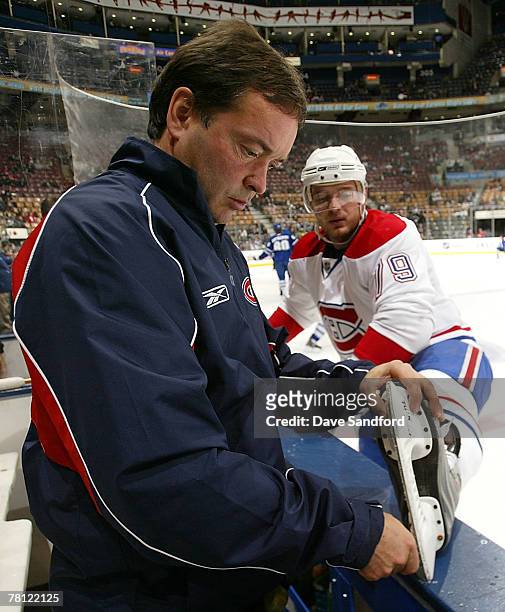 Montreal Canadiens Equipment Manager Pierre Gervais sharpens the edge of the skate of Andrei Markov of the Montreal Canadiens before facing the...