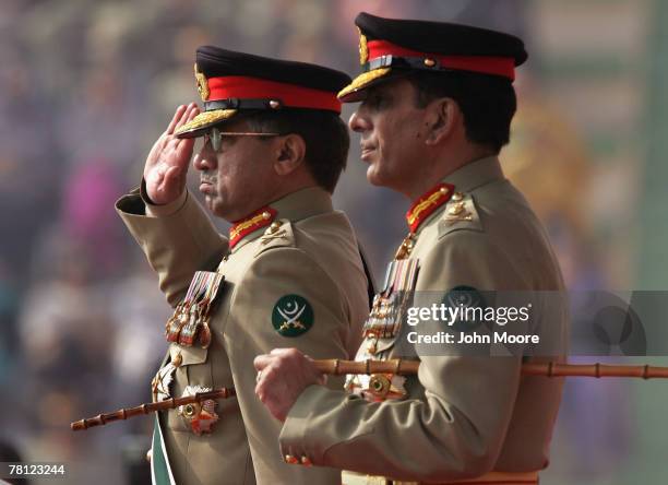 President Pervez Musharraf gives a farewell salute to Pakistani army troops while standing next to new army chief Gen. Ashfaq Kayani at a change of...