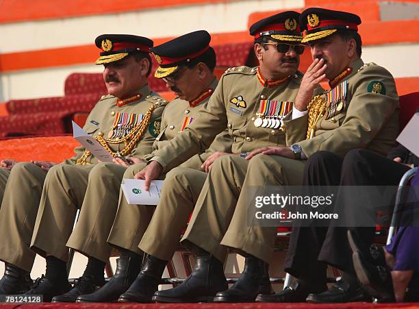 Pakistani military officers watch as President Pervez Musharraf hands over power to the new army chief Gen. Ashfaq Kayani at a change of command...