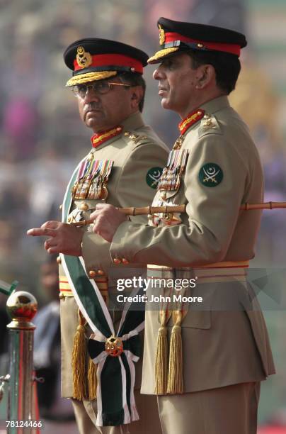 President Pervez Musharraf and the new Pakistani army chief Gen. Ashfaq Kayani watch as troops pass by during a change of command ceremony November...