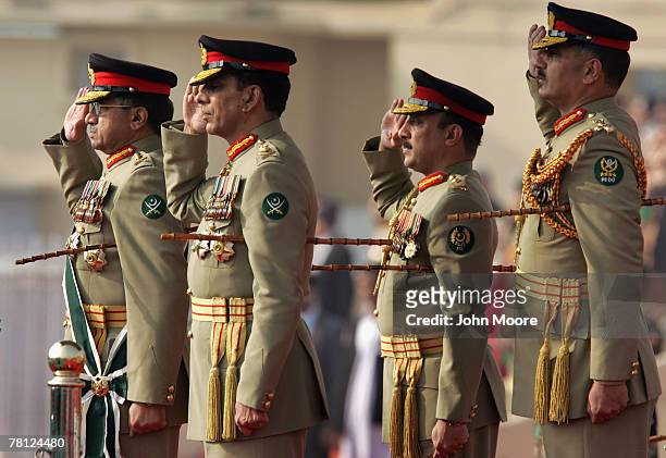 President Pervez Musharraf and the new Pakistani army chief Gen. Ashfaq Kayani salute as troops pass by during a change of command ceremony November...
