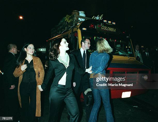 Actresses Cameron Diaz, right, Drew Barrymore, center, and Lucy Lou get on the bus from "Romancing the Stone" to travel to the premiere of their new...