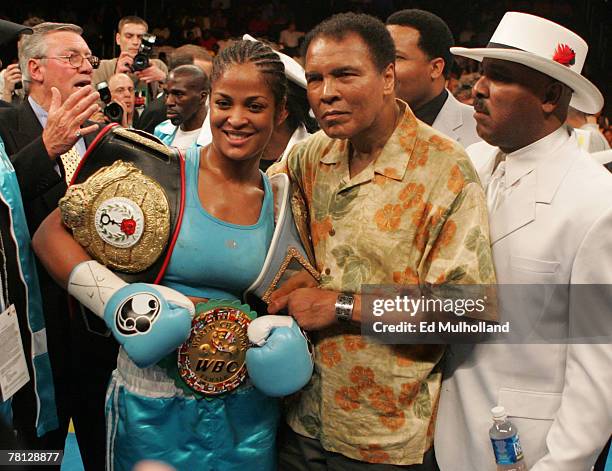 Laila Ali poses with her father, Muhammad Ali, after her 10 round WBC/WIBA Super Middleweight title bout with Erin Toughill at the MCI Center in...