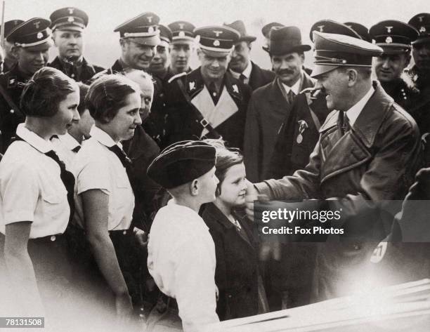 Nazi leader Adolf Hitler meets a group of young admirers in Breslau , March 1936. Looking on is German diplomat and future Ambassador to Britain,...