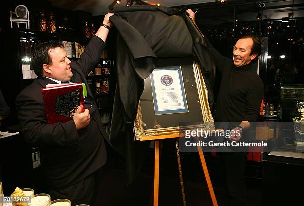 Editor- in-Chief of The Guinness World Records Book Craig Glenday presents Clive Christian creator of 'No.1 Perfume' with the official certificate...