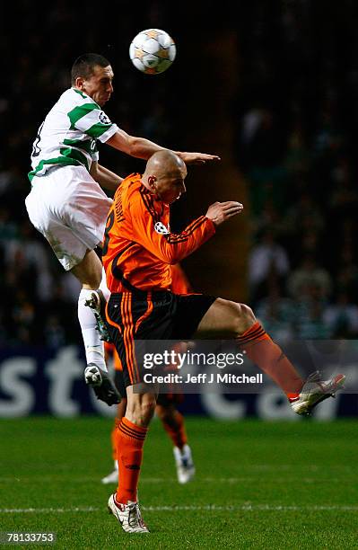 Scott Brown of Celtic tackles Mariusz Lewandowski of Shakhtar Donetsk during the UEFA Champions League Group D match between Celtic and Shakhtar...