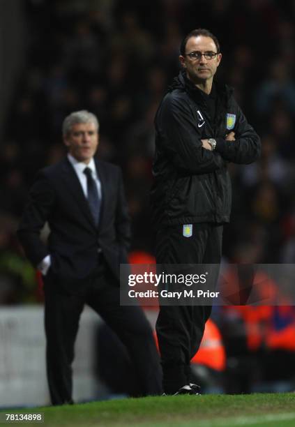 Aston Villa manager Martin O'Neill watches the action with Blackburn Rovers manager Mark Hughes in the background during the Barclays Premier League...