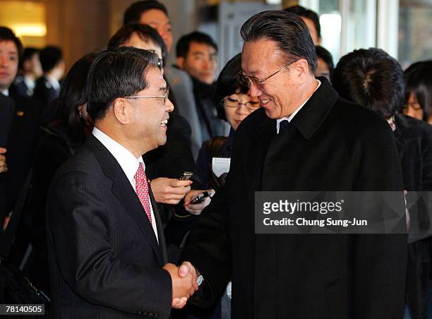 North Korea's United Front Department of Workers' Party Director Kim Yang-Gon shakes hands with South Korean Unification Minister Lee Jae-Joung upon...