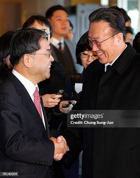 North Korea's United Front Department of Workers' Party Director Kim Yang-Gon shakes hands with South Korean Unification Minister Lee Jae-Joung upon...